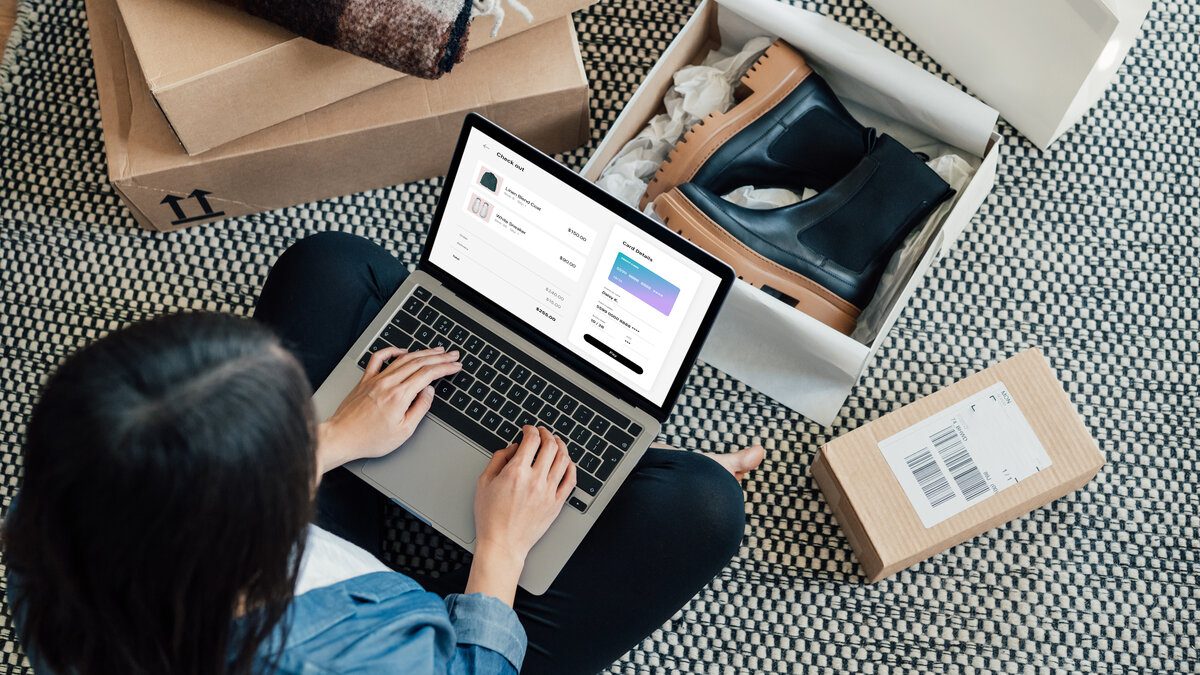 Overhead View Of Young Woman Doing Online Shopping With Laptop High angle view of young woman making credit card payment while doing online shopping on laptop. Technology makes shopping easier. Mockup image for woman doing online shopping.
