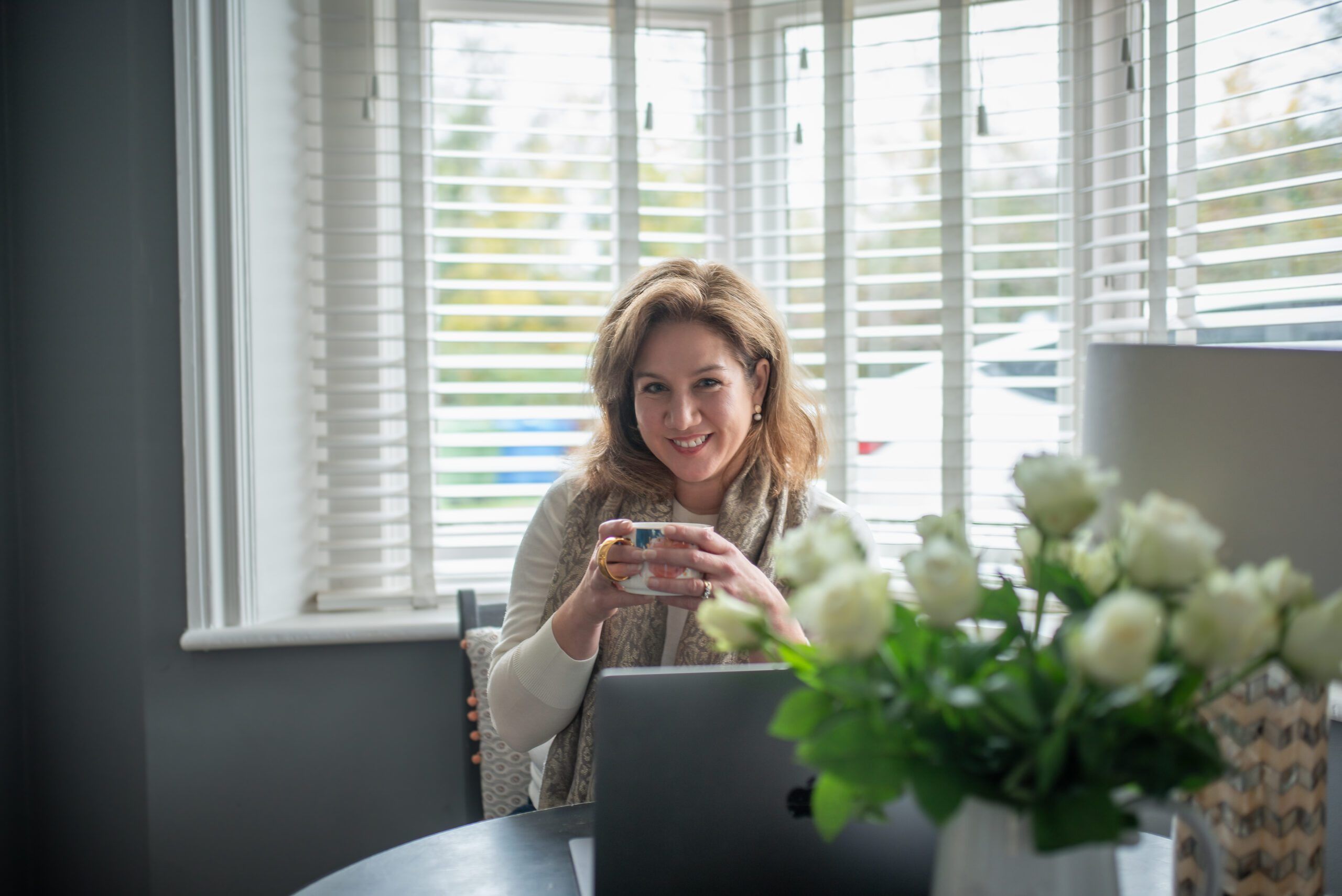 Isobel at a desk with coffee